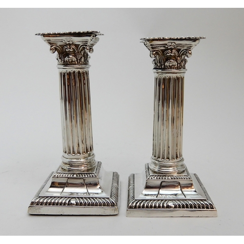 127 - A PAIR OF SILVER CANDLESTICKS