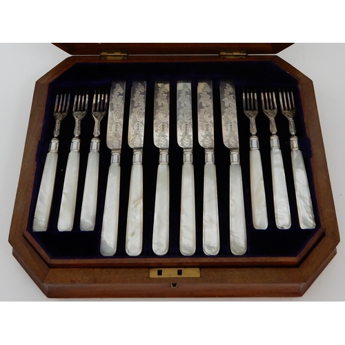 130 - A TWENTY FOUR PIECE SILVER AND MOTHER OF PEARL DESSERT CUTLERY SET