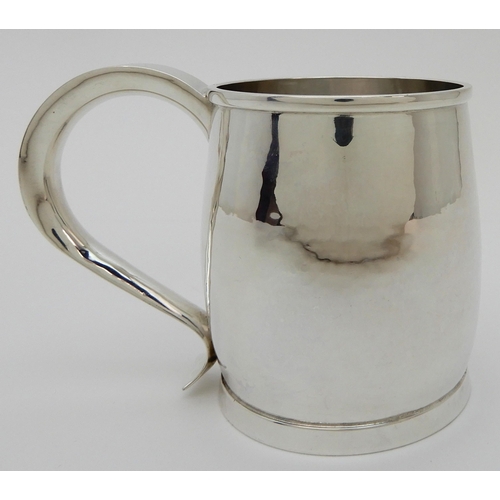 132 - A HAMMERED SILVER TANKARD