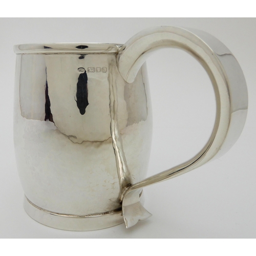 132 - A HAMMERED SILVER TANKARD