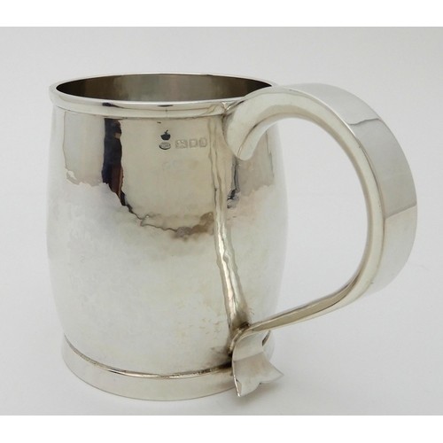 132 - A HAMMERED SILVER TANKARD