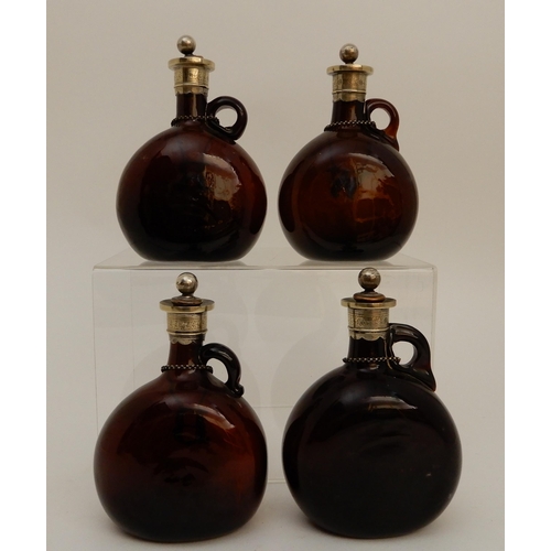 417 - A SET OF FOUR BROWN GLASS LIQUOR DECANTERS