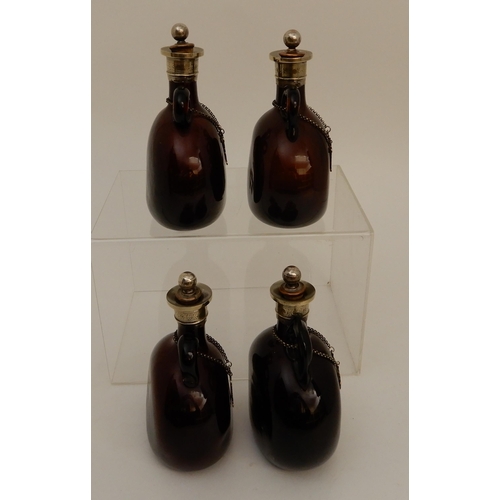 417 - A SET OF FOUR BROWN GLASS LIQUOR DECANTERS