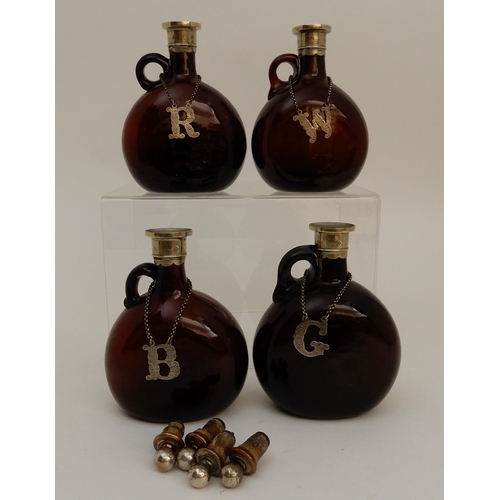 417 - A SET OF FOUR BROWN GLASS LIQUOR DECANTERS