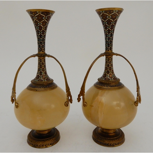 440 - A PAIR OF ONYX AND GILDED METAL VASE GARNITURES