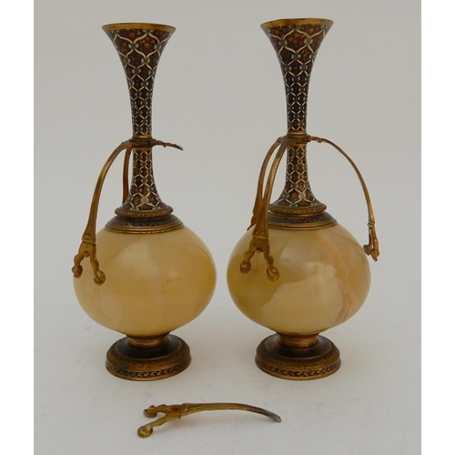 440 - A PAIR OF ONYX AND GILDED METAL VASE GARNITURES