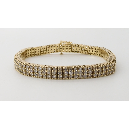 561 - A 14K GOLD THREE ROW DIAMOND LINE BRACELET