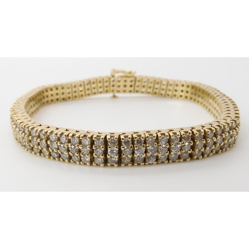 561 - A 14K GOLD THREE ROW DIAMOND LINE BRACELET