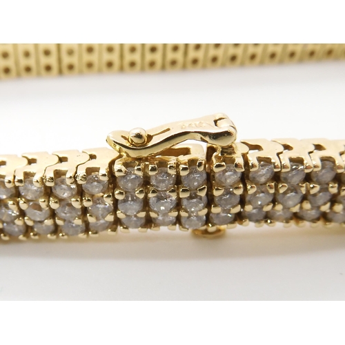 561 - A 14K GOLD THREE ROW DIAMOND LINE BRACELET