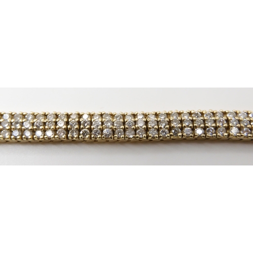 561 - A 14K GOLD THREE ROW DIAMOND LINE BRACELET