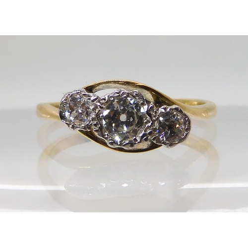 567 - AN 18CT AND PLATINUM THREE STONE RING