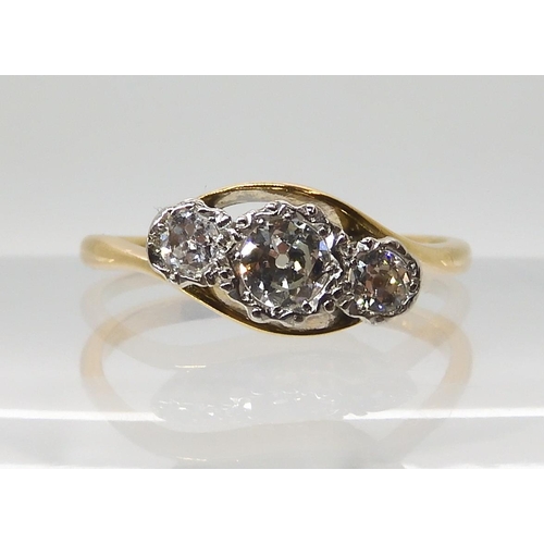 567 - AN 18CT AND PLATINUM THREE STONE RING