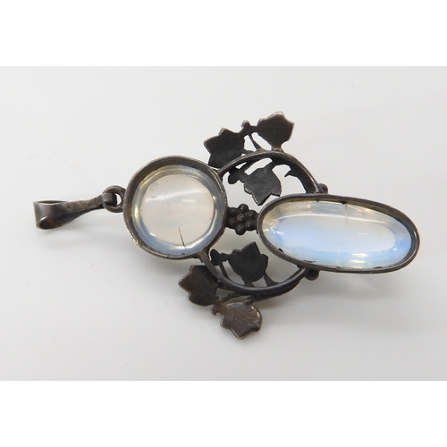 571 - A MOONSTONE AND ENAMEL PENDANT IN THE STYLE OF JESSIE M. KING