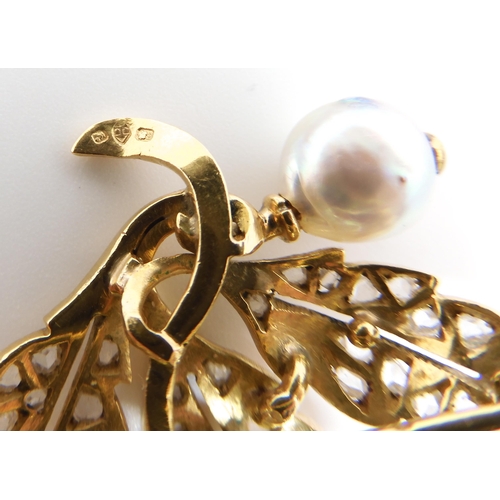 586 - A BRIGHT YELLOW METAL PEARL AND DIAMOND BROOCH