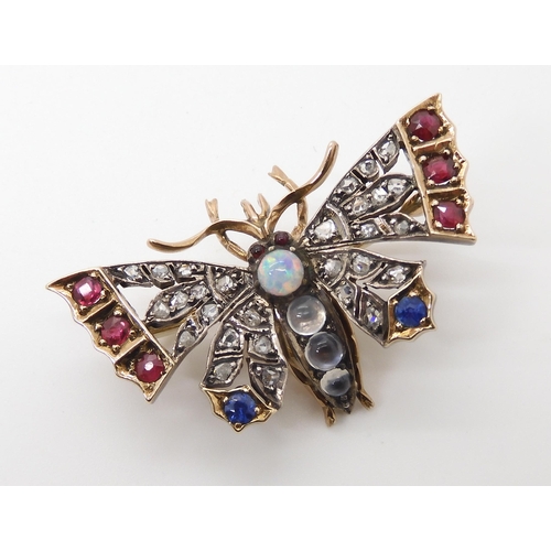 593 - A YELLOW AND WHITE METAL DIAMOND AND GEM SET BUTTERFLY BROOCH