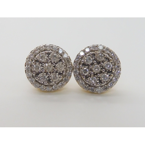 597 - A PAIR OF 9CT GOLD DIAMOND CLUSTER EARRINGS