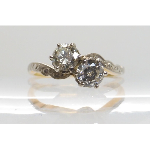 599 - AN 18CT GOLD AND PLATINUM TWIN STONE DIAMOND RING