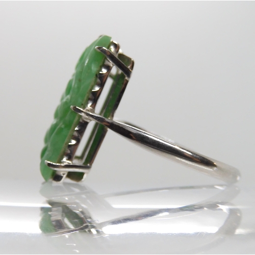 600 - A 9CT WHITE GOLD CHINESE GREEN HARDSTONE RING