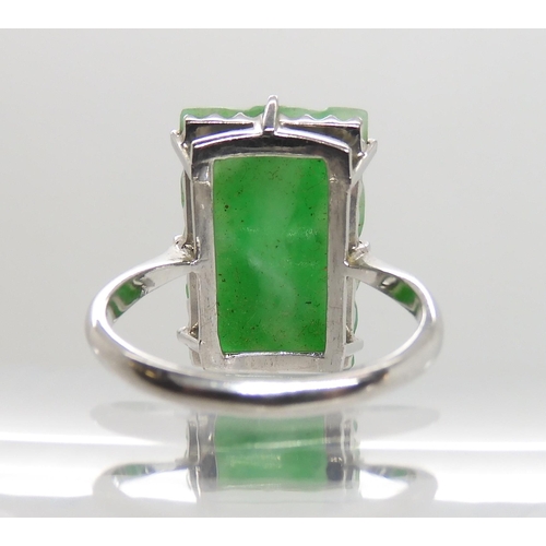 600 - A 9CT WHITE GOLD CHINESE GREEN HARDSTONE RING