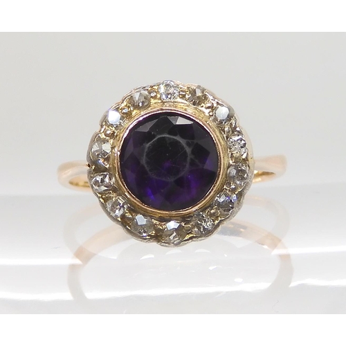 605 - A 9CT GOLD AMETHYST AND DIAMOND CLUSTER RING