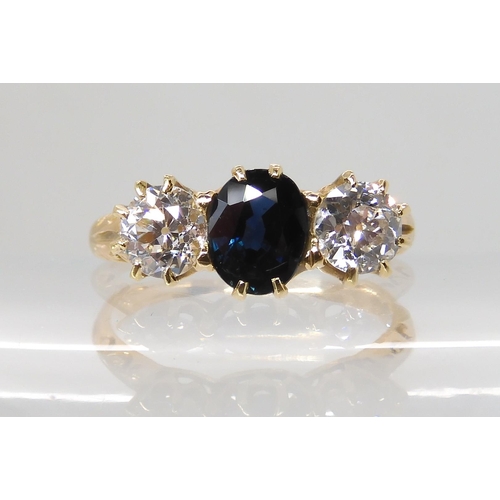 609 - A BRIGHT YELLOW METAL SAPPHIRE AND DIAMOND THREE STONE RING