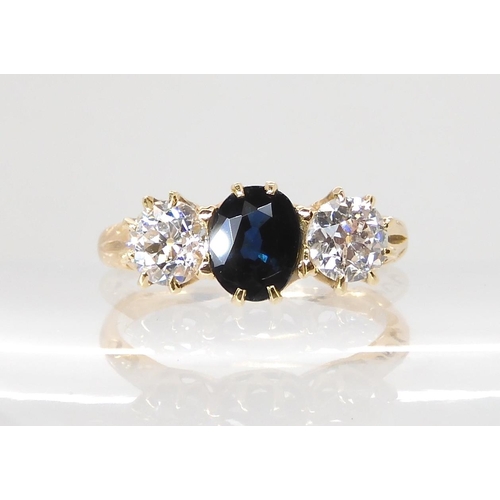 609 - A BRIGHT YELLOW METAL SAPPHIRE AND DIAMOND THREE STONE RING