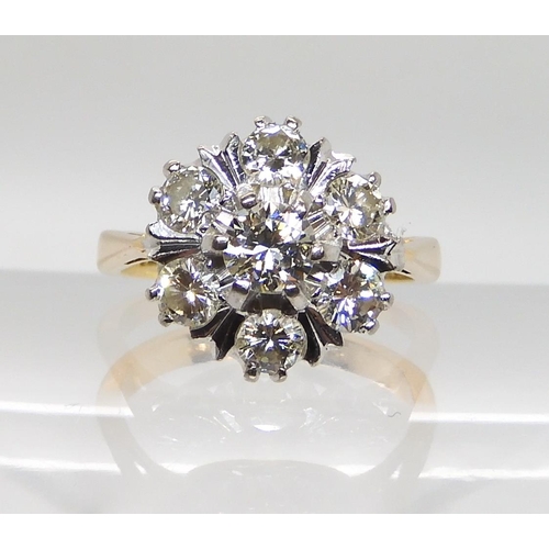 610 - AN 18CT GOLD DIAMOND FLOWER RING