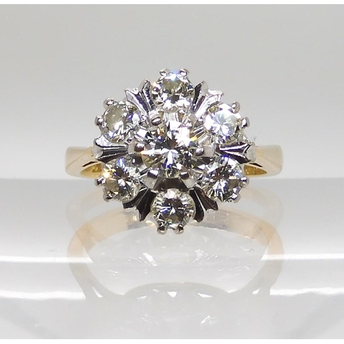 610 - AN 18CT GOLD DIAMOND FLOWER RING