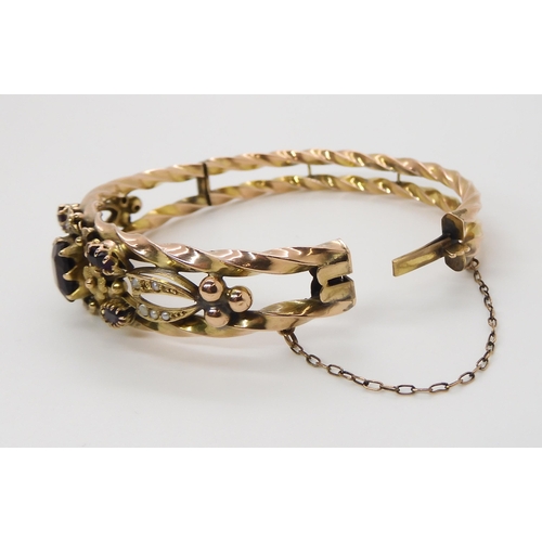 615 - A 9CT GOLD EDWARDIAN GEM SET BANGLE