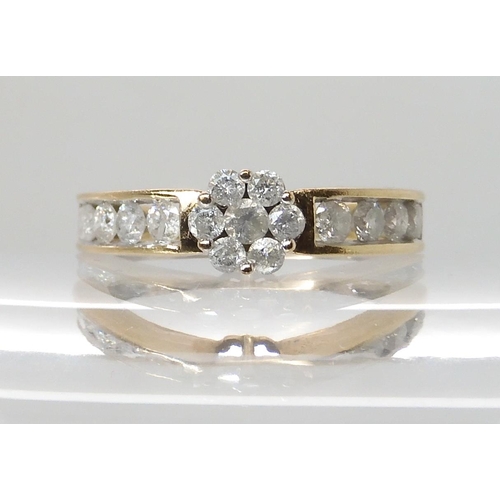 616 - A 9CT GOLD DIAMOND FLOWER RING