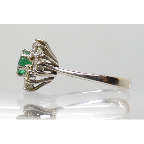 617 - AN 18CT WHITE GOLD EMERALD AND DIAMOND CLUSTER RING