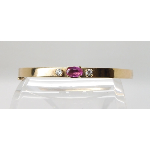 618 - A 9CT GOLD PINK SAPPHIRE AND CUBIC ZIRCONIA BANGLE