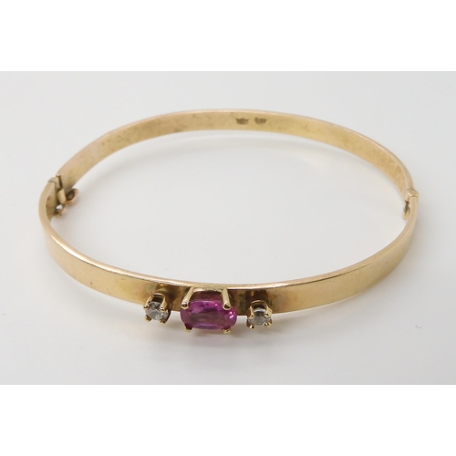 618 - A 9CT GOLD PINK SAPPHIRE AND CUBIC ZIRCONIA BANGLE