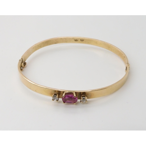 618 - A 9CT GOLD PINK SAPPHIRE AND CUBIC ZIRCONIA BANGLE