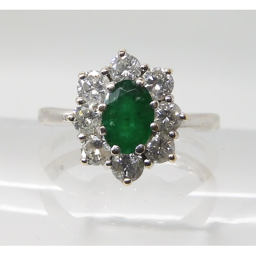 619 - A 9CT WHITE GOLD EMERALD AND DIAMOND CLUSTER RING