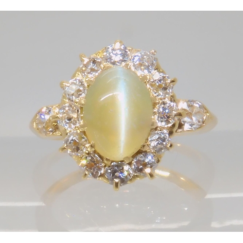 641 - A CHRYSOBERYL AND OLD CUT DIAMOND CLUSTER RING