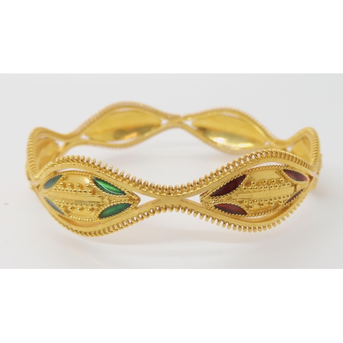 643 - A BRIGHT YELLOW METAL DECORATIVE BANGLE