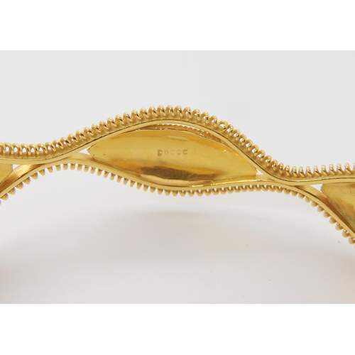 643 - A BRIGHT YELLOW METAL DECORATIVE BANGLE