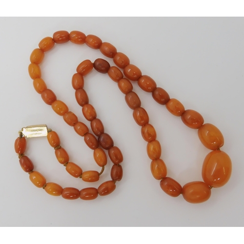 662 - A STRING OF AMBER  COLOURED BEADS