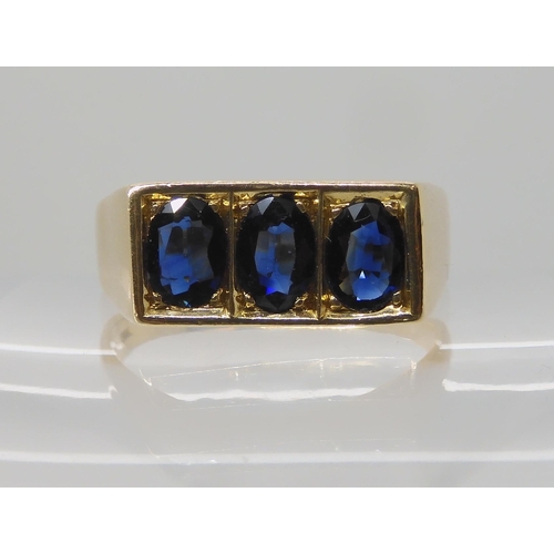 674 - A 14K GOLD GENTS THREE SAPPHIRE RING