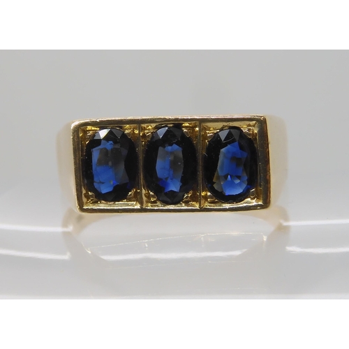 674 - A 14K GOLD GENTS THREE SAPPHIRE RING