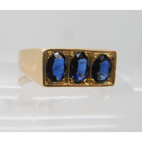 674 - A 14K GOLD GENTS THREE SAPPHIRE RING