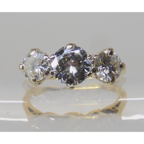 675 - AN 18CT GOLD THREE STONE DIAMOND RING