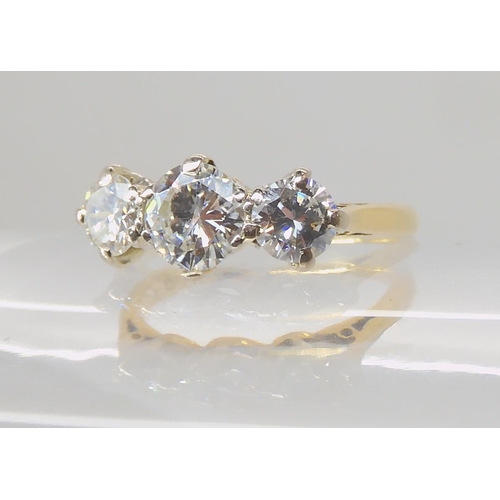 675 - AN 18CT GOLD THREE STONE DIAMOND RING