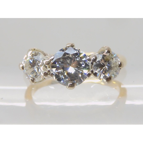 675 - AN 18CT GOLD THREE STONE DIAMOND RING