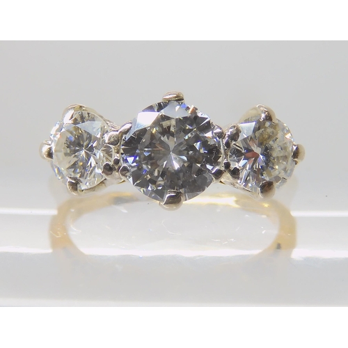 675 - AN 18CT GOLD THREE STONE DIAMOND RING