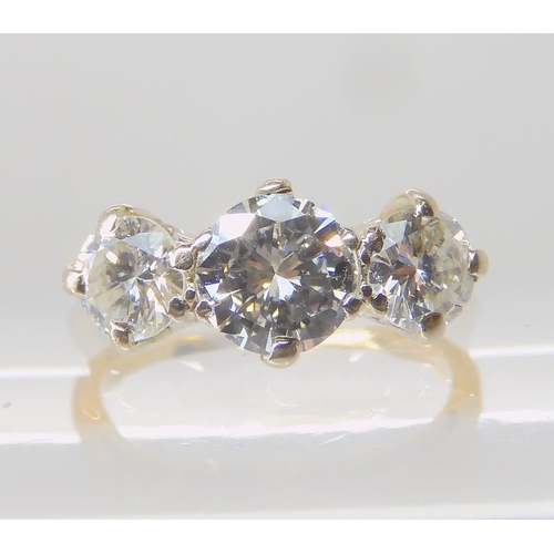 675 - AN 18CT GOLD THREE STONE DIAMOND RING