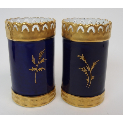 599 - A PAIR OF ROYAL WORCESTER TWO-HANDLED JARS AND COVERS