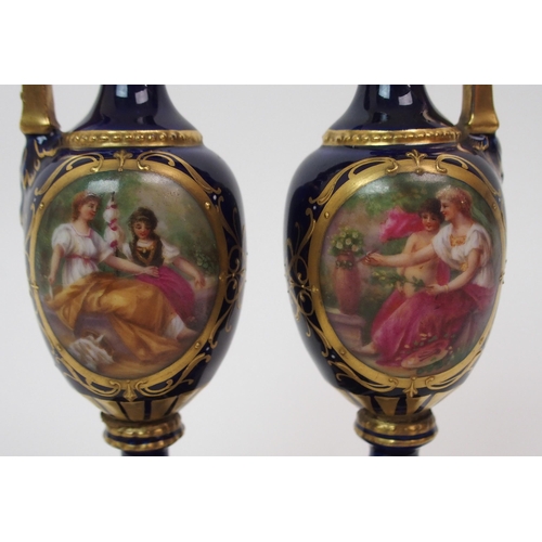 599 - A PAIR OF ROYAL WORCESTER TWO-HANDLED JARS AND COVERS