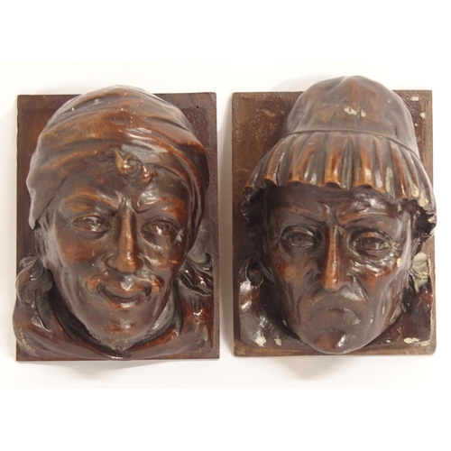 104A - A PAIR OF CARVED HEADS